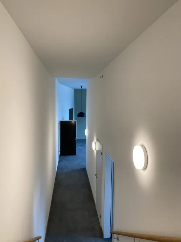 Fertig verputzter Korridor mit Wandleuchte
